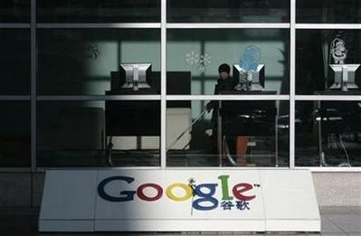 A cleaner looks out from the lobby of Google China's headquarters in Beijing, January 15, 2010.