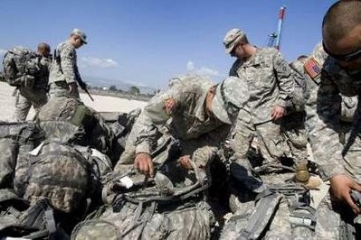 U.S. Marines arrive at a camp near Cite Soleil January 18, 2010. U.S. troops protected aid handouts and the United Nations sought extra peacekeepers in earthquake-shattered Haiti