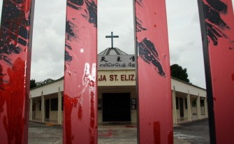 Red paint, splashed by unidentified vandals, covers the main gate of the St. Elizabeth Catholic church in Kota Tinggi of Malaysia's Johor state on Januray 14, 2010 (AFP photo)
