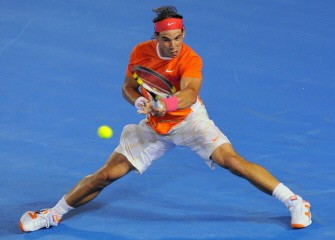 Nadal of Spain hits a return against Peter Luczak of Australia in their men's singles first round match on day one of the Australian Open tennis tournament in Melbourne on January 18, 2010. AFP photo)