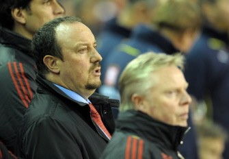 Rafael Benitez (C) stands before his team take on Tottenham Hotspur during their English Premier League football match at Anfield in Liverpool on January 20, 2010. AFP PHOTO