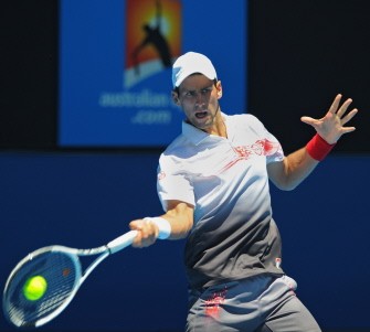 Djokovic hits a return against Marco Dhiudinelli of Switzerland in their men's singles second round match on day four of the Australian Open in Melbourne on January 21, 2010. AFP photo