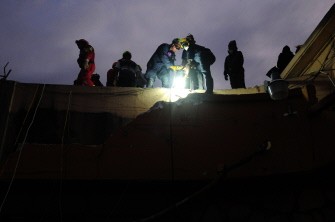 Search and Rescue teams from France, Haiti, Turkey, Fairfax County, Va. and members of the U.S. Air Force on Tuesday, Jan. 19, 2010 rescue Hottline Lozoma, a 25-year-old Haitian woman, who was trapped in rubble for eight days. (Photo: AFP)