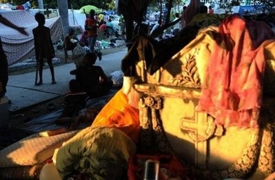 Haitians walk in a makeshift camp in Port-au-Prince