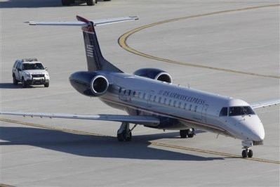 A plane is escorted by a law enforcement vehicle to a terminal at Philadelphia International Airport in Philadelphia, Thursday, Jan. 21, 2010