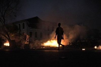 A Haitian walks past burning rubbish along a street in Port-au-Prince.