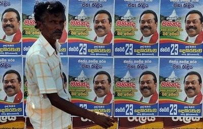 A Sri Lankan man walks past election posters of President Mahinda Rajapakse along the streets of Rajapakse's home town Tangalla, about 195 kms from the capital Colombo. (AFP Photo)