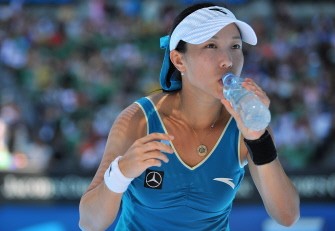 Zheng Jie has a drink between games while playing against Maria Kirilenko of Russia in their women's singles quarter-final match on day nine of the Australian Open in Melbourne on January 26, 2010. AFP PHOTO