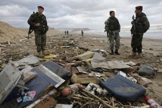 Lebanese soldiers stand near debris and personal belongings of passengers aboard the Ethiopian airliner (AFP photo)