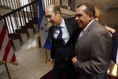 Honduras' President-elect Porfirio Lobo (R) smiles with U.S. Ambassador to Honduras' Hugo Llorens before a private meeting inside Llorens' residency in Tegucigalpa January 26, 2010