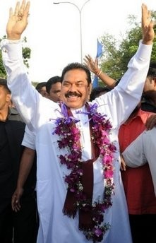 Sri Lankan President Mahinda Rajapakse acknowledges cheers from his supporters in Colombo