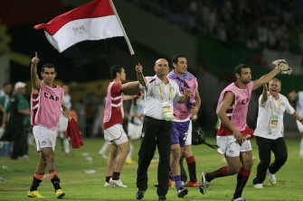 Egyptian players and team staff celebrate their victory over Algeria during their semi final match in the African Cup of Nations CAN2010 at the Ombaka stadium in Benguela on January 28, 2010. AFP PHOTO