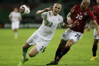 Wael Gomaa (R) of Egypt vies for the ball with Madjid Bougherra of Algeria during their semi final match in the African Cup of Nations CAN2010 at the Ombaka stadium in Benguela on January 28, 2010. AFP PHOTO