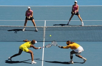 Serena (bottom R) and Venus Williams (bottom L) reach for a return against Cara Black of Zimbabwe (top R) and Liezel Huber of the US (top L) in the women's doubles final on day 12 of the Australian Open tennis tournament in Melbourne on January 29, 2010. AFP photo