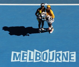 Serena Williams (R) and sister and partner Venus Williams of the US (L) pose with the winner's trophy following their victory over Cara Black of Zimbabwe and Liezel Huber of the US in the women's doubles final on day 12 of the Australian Open tennis tournament in Melbourne on January 29, 2010. AFP photo