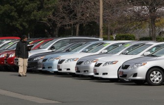 A worker takes inventory of new Toyota cars at Hanlees Hilltop Toyota January 29, 2010 in Richmond, California, USA. AFP photo