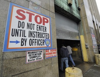 A New York City police officer enters the Manhattan Detention Complex in lower Manhattan January 28. AFP photo