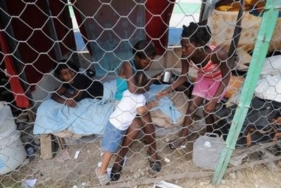 Children sit in their shelter at a makeshift camp in Port-au-Prince. AFP photo