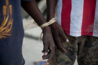 Two suspected looters are tied up in Port-au-Prince on January 30, 2010. AFP photo