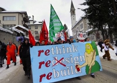 A demonstrator holds a banner during a rally against the annual meeting of the World Economic Forum attended by the world's business and political elite on January 30, 2010 in Davos. AFP photo