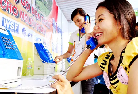 Niềm vui của công nhân xa nhà được gọi điện thoại miễn phí thăm gia đình. Ảnh: VIỆT DŨNG