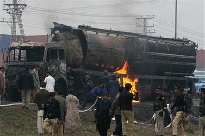 Pakistani fire fighters trying to extinguish burning oil tanker carrying fuel supplies for NATO forces in neighboring Afghanistan.