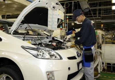 A Toyota Motors Tsutsumi factory worker assembles a Prius hybrid vehicle in Toyota City, Aichi prefecture