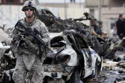 A US soldier secures the site of a bomb blast in northern Baghdad.