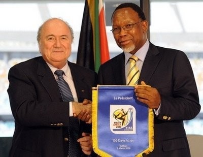 FIFA president Sepp Blatter (left) gives a flag to mark 100 days to go to until the World Cup to South Africa's Deputy President Kgalema Motlanthe during a press conference in Durban. AFP photo