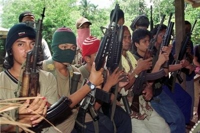 Abu Sayyaf gunmen display their weapons in their jungle camp in Jolo in 2000. (AFP Photo)
