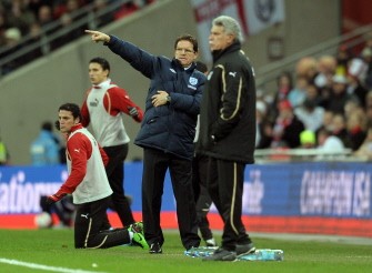 England manager Fabio Capello (2R) and Egypt manager Hassan Shehata (R) direct their teams during their friendly international football match at Wembley Stadium in London on March 3, 2010. AFP PHOTO
