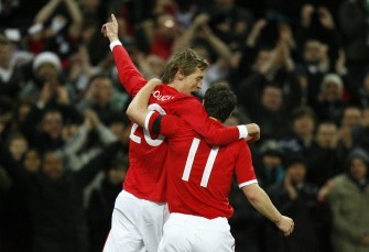 England's Peter Crouch celebrates scoring his goal against Egypt with England's Gareth Barry during an International friendly at Wembley Stadium in London on March 3, 2010. AFP PHOTO