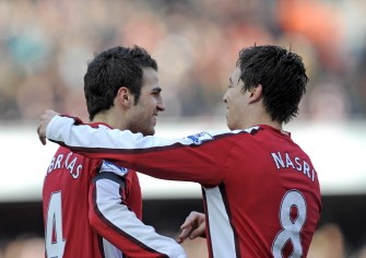 Cesc Fabregas (L) celebrates scoring the opening goal with French midfielder Samir Nasri during the English Premier League football match between Arsenal and Burnley at the Emirates stadium, on March 6, 2010. AFP PHOTO