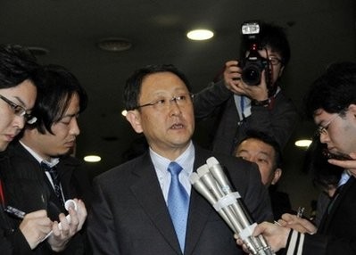 Japan's auto giant Toyota Motor president Akio Toyoda is surrounded by reporters