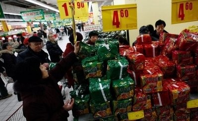 People are pictured shopping for food at a supermarket in Beijing.