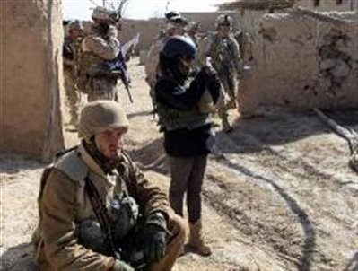 Author Golnar Motevalli is seen with U.S. soldiers the centre of Marjah February 17, 2010