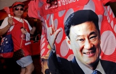 Supporters of fugitive former premier Thaksin Shinawatra dance as they gather at 'Red Shirt' TV station in Bangkok, on March 11.