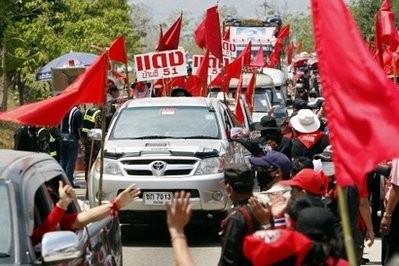 Supporters of deposed Thai premier Thaksin Shinawatra greet each other as thousands of them leave Thaksin's home city Chiang Mai for Bangkok in a convoy of vehicles on March 12. AFP photo