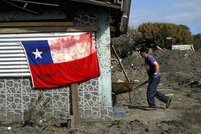 A man cleans the debris around his house which was destroyed by the massive 8.8-magnitude earthquake in Constitucion on March 11. AFP file photo