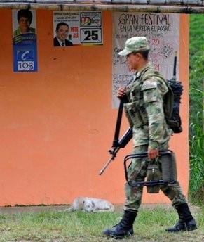 A Colombian soldier walks past election posters near the Pan-American Highway. AFP photo