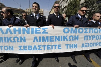 A group of striking policemen hold a large banner as they march in Athens on March 11, 2010 during a demonstration marking the general strike. AFP photo