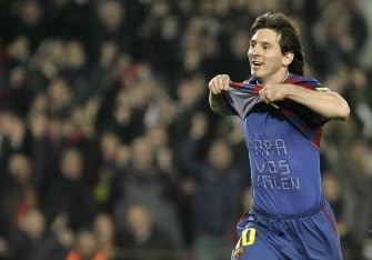Lionel Messi postures after his goal during a Spanish League football match against Valencia at the Camp Nou Stadium in Barcelona, on March 14, 2010. AFP PHOTO