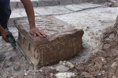 An archeologist cleans the stone engraved with a seven-branched Menorah (candelabrum), in Israel, in 2009.