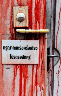 Blood stains the entrance gate to Prime Minister Abhisit Vejjajiva's residence after supporters of deposed Thai premier Thaksin Shinawatra poured blood over it during an anti-government protest, in Bangkok on March 17, 2010. AFP photo
