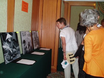 Visitors enjoy photographs in the auction in HCM City on March 12. (Photo: Huynh Thao)