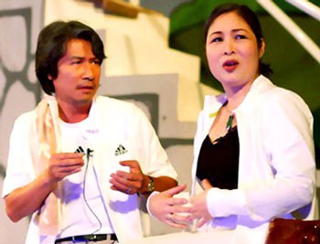 Actress Hong Van (R) performs in the play Me va nguoi tinh (Mother and her lover)