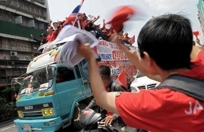 Red-shirted supporters of deposed Thai premier Thaksin Shinawatra parade through the streets of Bangkok.