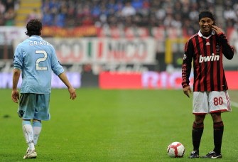 AC Milan's Brazilian forward Ronaldinho (R) gestures after a tackle with Naples' defender Gianluca Grava (L) during their Italian serie A football match AC Milan vs Napoli at San Siro stadium in Milan on March 21, 2010. AFP PHOTO