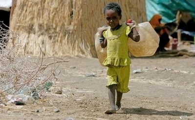 File photo shows a girl carrying plastic jugs to fill up with water at the Shegerab refugee camp in the Kassala State, eastern Sudan in Feburary 2010.