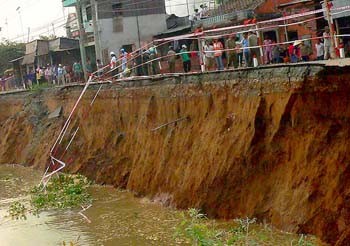 A section of Highway 91 in An Giang Province fell into the Hau River on March 22, narrowing the roadway to just one meter wide (Photo: SGGP)